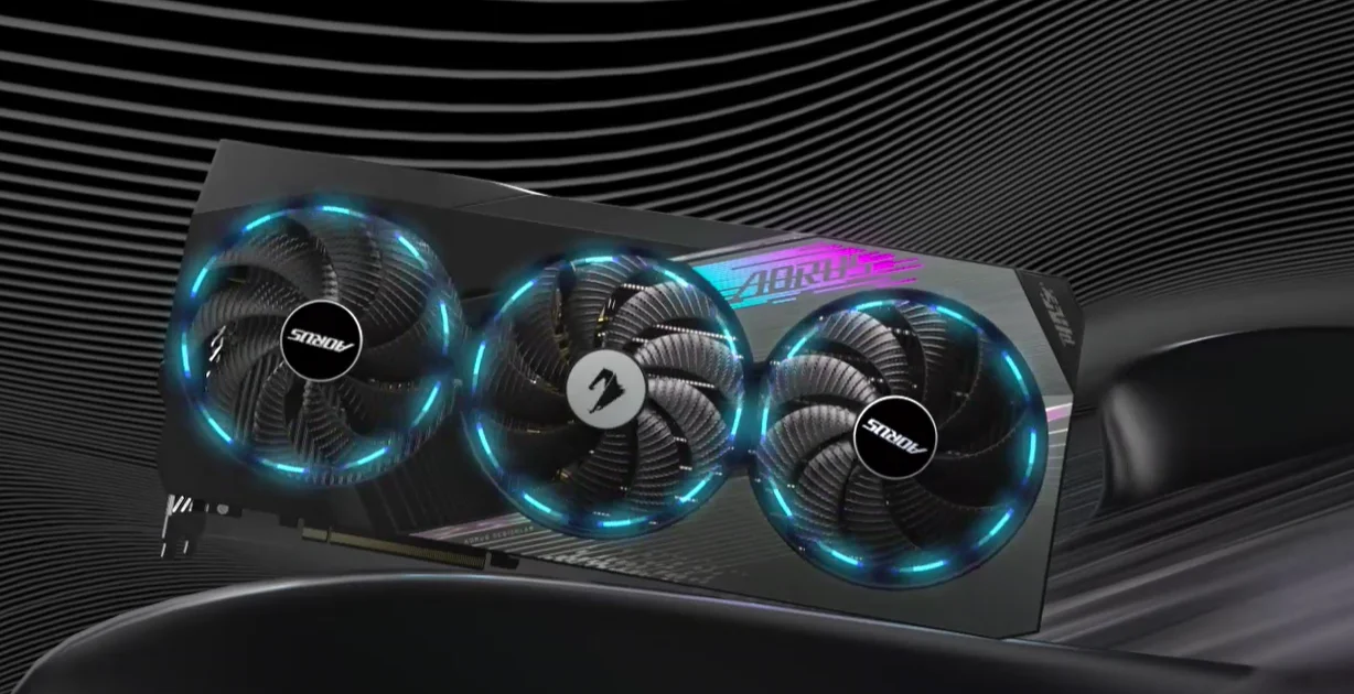 Card màn hình GIGABYTE AORUS GeForce RTX 4080 MASTER 16G có thiết kế chắc chắn với lớp vỏ kim loại màu tối, kết hợp đèn LED RGB sáng màu tạo điểm nhấn hiện đại. Card có kích thước lớn với ba quạt tản nhiệt đặt song song trên bề mặt, mỗi quạt có cánh quạt thiết kế tinh tế giúp làm mát hiệu quả. Phía sau là tấm chắn kim loại cứng cáp, bảo vệ các linh kiện bên trong. Các cổng kết nối bao gồm nhiều cổng DisplayPort và HDMI, được sắp xếp gọn gàng ở một cạnh, thuận tiện cho việc kết nối nhiều màn hình. Tổng thể sản phẩm mang vẻ ngoài mạnh mẽ, cao cấp, thể hiện hiệu suất và độ bền vượt trội.